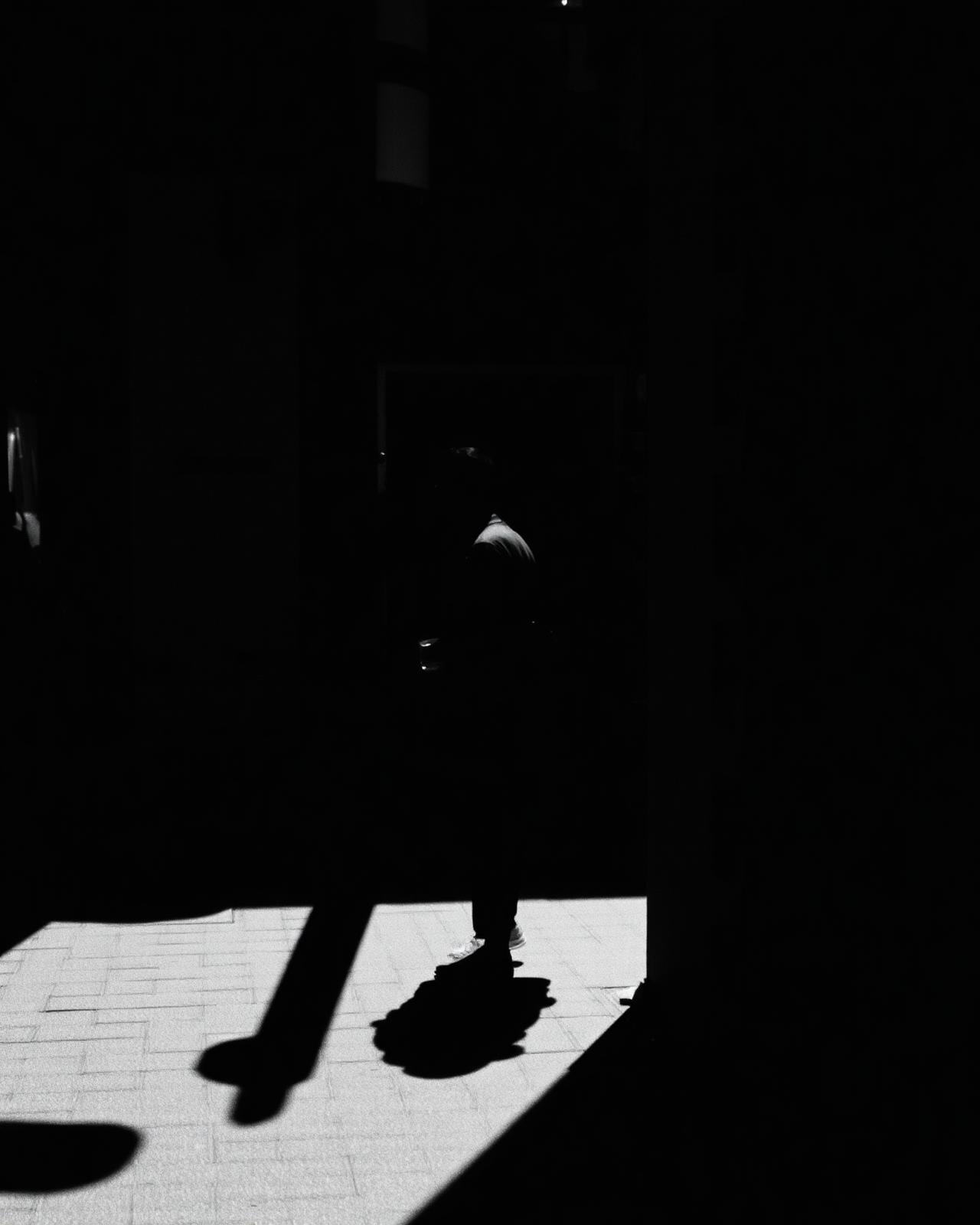 Black and white urban scene with dramatic shadows